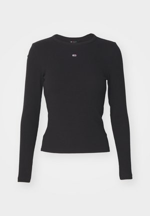Sort langærmet top lavet af ribbet stof med rund halsudskæring. Lille logo centreret på brystet. Tætsiddende silhuet, glat tekstur.