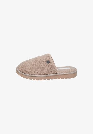 Chausson beige avec un extérieur texturé et duveteux, et une semelle plate. Présente un accent logo subtil sur le côté et un design de bout arrondi.