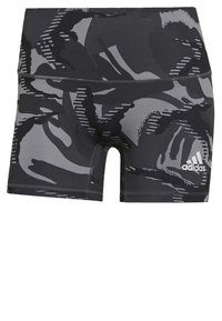 Pantaloni sportivi neri e grigi con motivo camouflage, tessuto elastico, vita alta e logo adidas bianco in basso a destra.