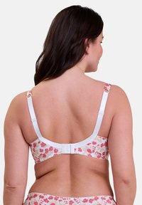 Reggiseno a fantasia floreale con fascia bianca e spalline regolabili, chiusura con gancio e asola sul retro. Il design enfatizza il comfort.