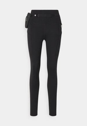 Leggings negros fabricados con un tejido elástico, con una cinturilla alta, bolsillos laterales, un bolsillo con cremallera y un cinturón desmontable con detalles de herrajes.