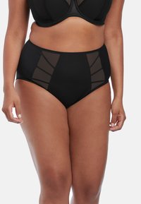 Zwarte bikini met hoge taille heeft meshpanelen aan de zijkanten, stevige stof in het midden en een zachte textuur. Ontworpen voor comfort en bedekking.