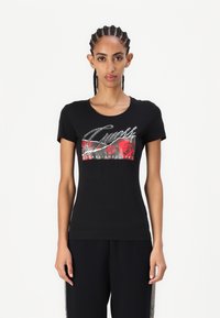 Black cotton t-shirt with a round neckline, featuring a colorful floral graphic and rhinestone accents on the front. Short sleeves.