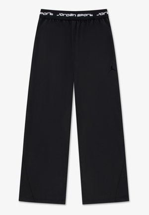 Schwarze, weit geschnittene Sporthose mit elastischem Bund, verziert mit weißem "Jordan Sport"-Schriftzug und dezentem Jumpman-Logo am rechten Oberschenkel.