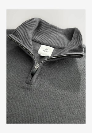 Gray zip-up sweater with ribbed collar, textured fabric, and small logo label. Features a silver zipper with a black pull tab.