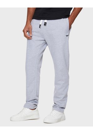 Hellgraue Sweatpants aus Baumwollmischgewebe. Mit weißen Kordeln, Seitentaschen und einem kleinen Logo auf der Hüfte.