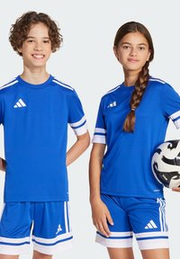 Camisetas y pantalones cortos deportivos azules con acentos blancos, hechos de un tejido ligero. Presenta un logo en el pecho y en las mangas, y un balón de fútbol.