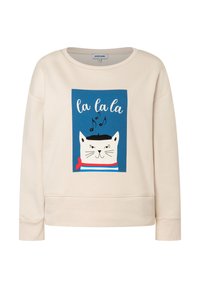 Beige sweatshirt met een blauwe vierkant waarop een witte kat te zien is die een zwarte baret en een rode sjaal draagt, muzikale noten en de tekst "la la la" erboven.
