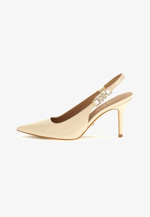 Beige patent leather slingback pump with pointed toe, adjustable strap, and metallic accent detail on the heel. Thin high heel.