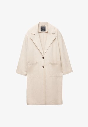 Beige linnen coat med en lös passform, detaljer vid axelsömmen, två framfickor och en enkelknappsstängning. Har en klassisk notch-krage.