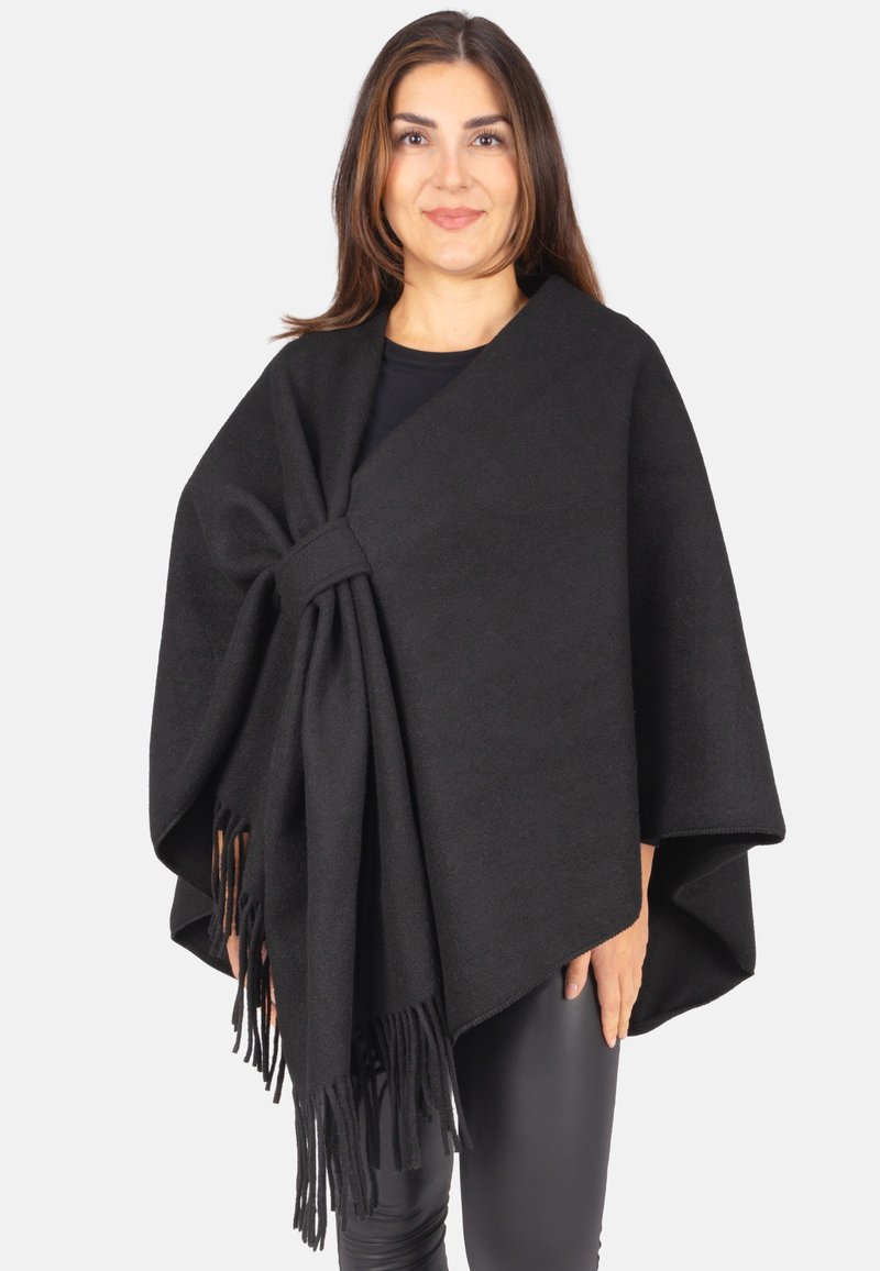 Schwarzer Poncho aus weichem Stoff, mit elegantem Fall, Knotendetail an der Schulter und fransigen Kanten. Geeignet zum Schichten.