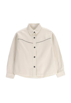 Kremowa koszula na guziki z długimi rękawami, czarne zatrzaski, spiczasty kołnierz i ozdobne czarne koraliki na wysokości klatki piersiowej.