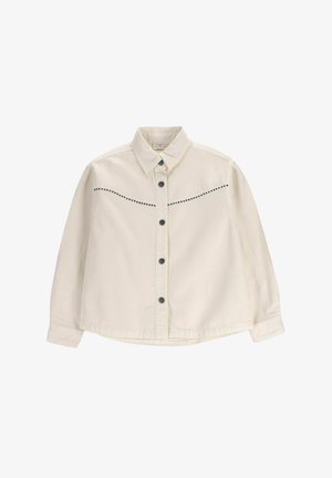 Kremowa koszula na guziki z długimi rękawami, czarne zatrzaski, spiczasty kołnierz i ozdobne czarne koraliki na wysokości klatki piersiowej.