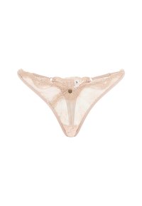 Lace thong in nude with scalloped edges, transparent mesh panels, and decorative hardware. Features size tag 'S' near the waistband.