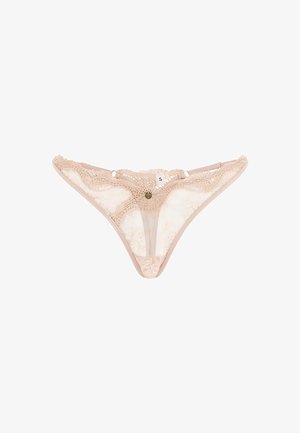 Tanga en nude avec des bords festonnés, des panneaux en mesh translucides et des embellissements décoratifs. Comprend une étiquette de taille 'S' près de la ceinture.