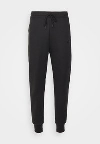 Schwarze Sweatpants mit einem Kordelzugbund, gerippten Bündchen, Seitentaschen und einem kleinen Logo auf dem Oberschenkel. Hergestellt aus einem weichen Stoff mit glatter Textur.