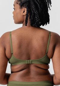 Olive green bra with adjustable straps and a hook-and-eye closure. Smooth, stretchy fabric with a simple design and no visible patterns.