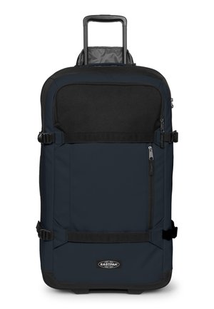 Maleta Eastpak con ruedas en azul oscuro y negro con asa telescópica, bolsillo frontal con cremallera y correas ajustables en los laterales.