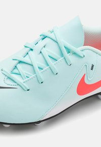 Light blue synthetic football shoe with pink accents, featuring flat laces, a sleek design, and black outsole with white studs.