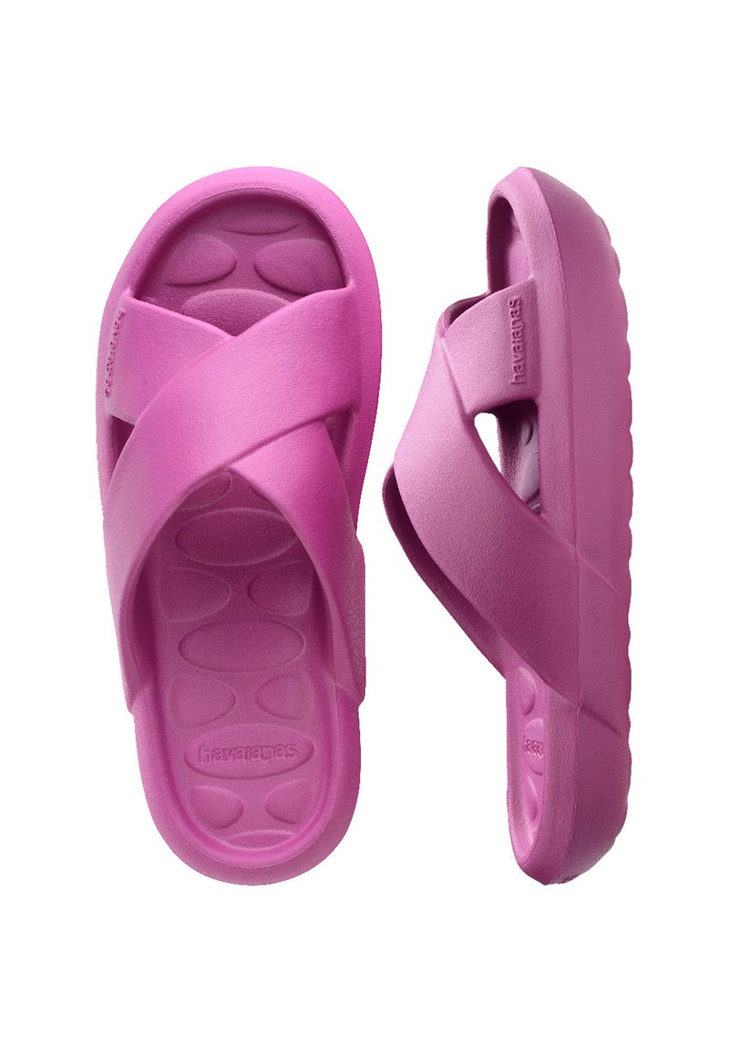 Pink rubber sandals with a cross strap design, textured footbed, and a thick sole. Lightweight with rounded edges.