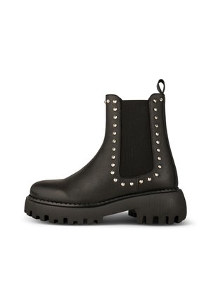 Bota de tobillo de cuero negro con suela gruesa tipo lug, paneles laterales elásticos, tachuelas redondas plateadas que delinean los paneles y una lengüeta para tirar en la parte trasera.