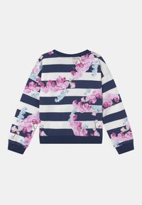 Felpa a righe navy e bianche con un motivo floreale che presenta orchidee rosa e blu chiaro. Collo a giro e maniche lunghe. Tessuto morbido.