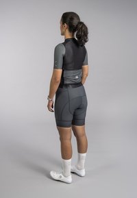 Athletic outfit featuring a fitted black and gray short-sleeve top, gray shorts with stitching details, and white sports shoes.