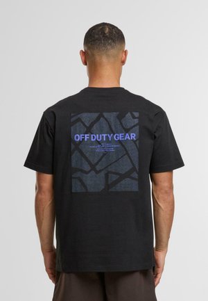 Tricou negru din bumbac cu un grafic mare pe spate, având un model texturat închis la culoare și text albastru care spune "ECHIPAMENT ÎN AFARĂ DE SERVICIU."