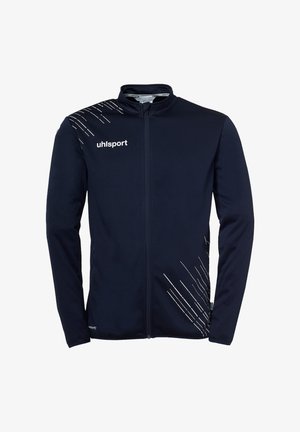 Giacca sportiva blu navy con cerniera frontale completa, motivi a linee diagonali bianche e logo "uhlsport" sul petto e sulla spalla.