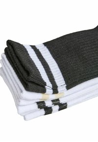 Bawełniane skarpetki w kolorze czarnym i białym, z żebrowaną fakturą i poziomymi paskami. Stos prezentuje naprzemienne kolory i czyste krawędzie.
