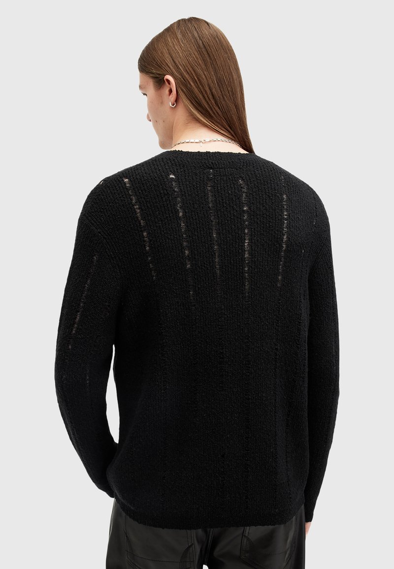 Schwarzer Strickpullover mit strukturiertem Muster und offener Webart, ausgestattet mit Rundhalsausschnitt und langen Ärmeln, entworfen für eine lässige Passform.