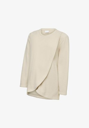 Cream-colored long-sleeve fleece top with round neckline and asymmetrical layered front panel.