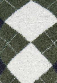 Sötétzöld, fehér és tengerészkék argyle minta. Puha, bolyhos textúra, négyszögekkel és kontrasztos körvonalakkal. Kötött anyag dizájn.