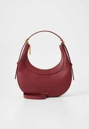 Burgundy leather handbag with a rounded shape, top handle, and a detachable strap. Features gold-tone hardware and textured finish.