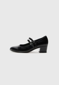 Chaussure Mary Jane en cuir verni noir avec un bout rond, deux brides réglables et un talon bloc. Texture lisse avec un éclat subtil.