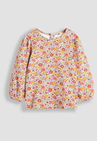 Bluse mit langen Ärmeln im floralen Design auf weißem Hintergrund mit roten, pinken und gelben Blumen. Runde Ausschnittform und elastische Ärmelabschlüsse.