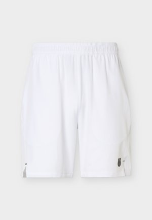 Valged spordipüksid elastse vöökohaga ja väike must logo alumisel paremal jalal, esitatuna ühtlasel heledal taustal.