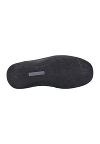 Semelle en caoutchouc avec une surface texturée et un motif de semelle. Couleur : noire. Présente une étiquette de marque embossée sur le côté.