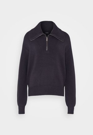 Tamno plava pletena pulover s polu-zatvaračem, rebrastim manžetama i teksturiranim uzorkom na tijelu. Mekana, srednje teška tkanina.