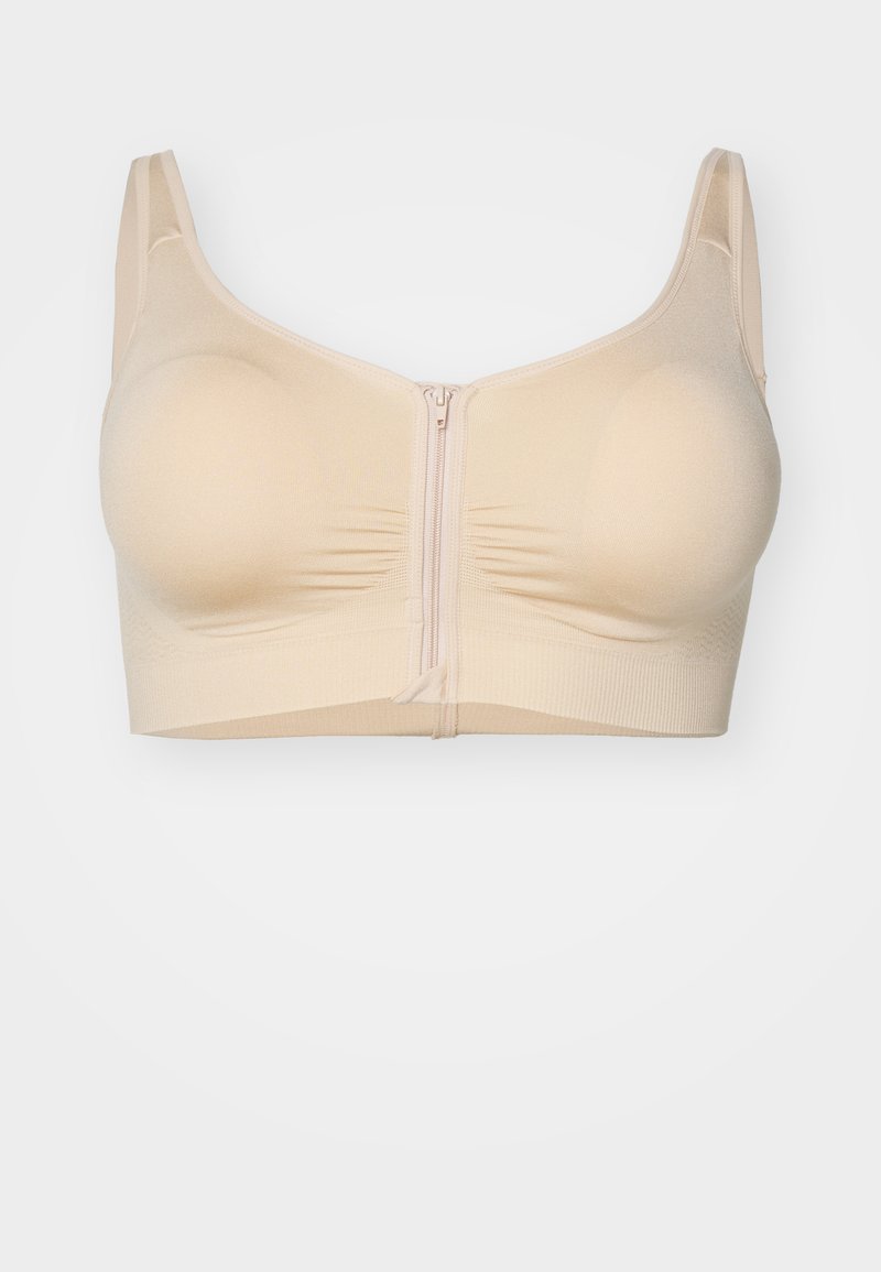 Beige wireless bra featuring a zip closure at the front, with soft, stretchy fabric and ruching details for a smooth appearance.