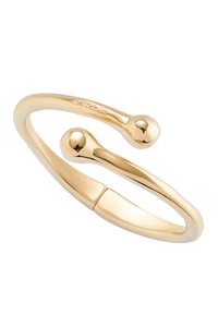 Bracelet ajustable doré au design lisse et arrondi, présentant deux extrémités sphériques et une finition brillante et élégante.