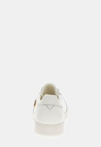 Sneaker bianca con parte superiore in pelle liscia, forma arrotondata, colletto imbottito e un accento decorativo dorato sul lato.