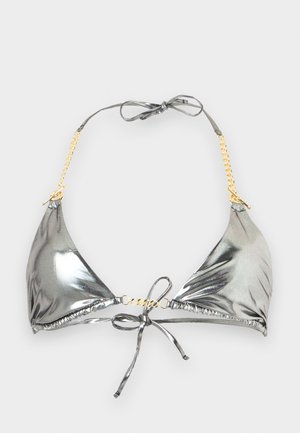 Zilverkleurige metallic driehoekige bikinibovenkant met gouden kettingbandjes en verstelbare strikjes bij de hals en rug op een effen achtergrond.