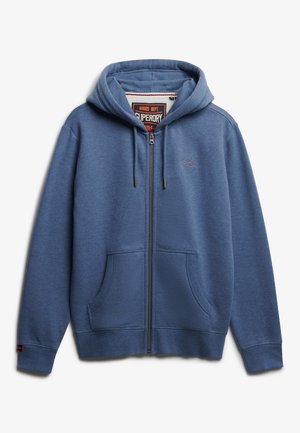 Hoodie zippé bleu en matériau doux, avec une poche avant, une capuche ajustable et un détail de logo sur la poitrine.