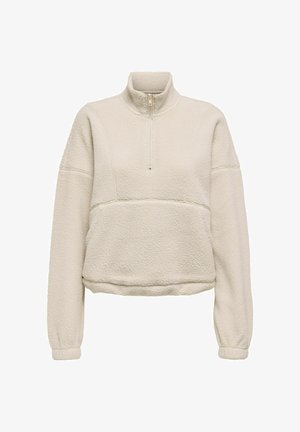 Bluza polarowa w jasnobeżowym kolorze z dekoltem na zamek do połowy wysokości. Posiada teksturowaną tkaninę i opuszczane ramiona oraz ściągacze na mankietach.