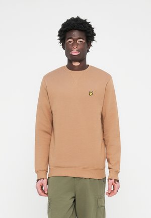Ljusbrun sweatshirt i bomullsmix, med ribbad rundhals och mudd, prydd med en liten gul fjärilslogotyp på bröstet.