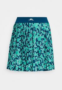 Fållad kjol i nyanser av grönt och blått, med ett blommönster och en enfärgad blå midjeband med logotypdetalj fram.