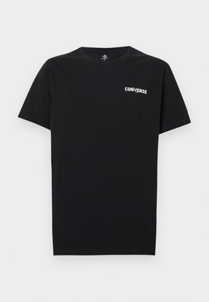Melnas kokvilnas t-krekls ar apaļu kakla izgriezumu un īsām piedurknēm, kreisajā krūtīs baltā krāsā ar "CONVERSE" logo. Gluda tekstūra un parasts piegriezums.