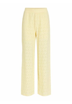 Pantalon large jaune clair avec motif perforé en forme de losange, taille élastique et texture de tissu douce.