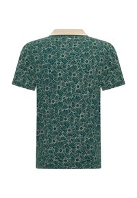Polo de manga corta en verde oscuro con un patrón floral en crema, con un cuello crema y una tela texturada.